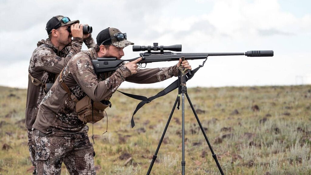 Hunting rifle with suppressor on bipod